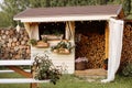 Firewood-filled shed in a neat backyard