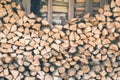 Firewood or fuelwood stacked by a wall. Texture woodpile Royalty Free Stock Photo