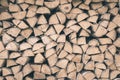 Firewood or fuelwood stacked by a wall. Texture woodpile Royalty Free Stock Photo