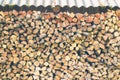 Firewood or fuelwood stacked by a wall. Texture woodpile Royalty Free Stock Photo