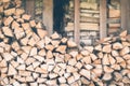 Firewood or fuelwood stacked by a wall. Wooden pile prepared for winter. Fuel for countryside fireplace. Forest timber Royalty Free Stock Photo