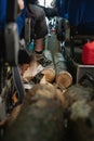 Firewood lying in cabin of tourist bus on floor. Transportation of logs. Extreme tourism Royalty Free Stock Photo