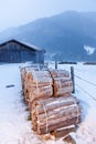 Firewood near a barn illuminated Royalty Free Stock Photo