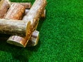 Firewood piles placed on artificial grass