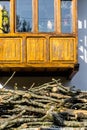 Firewood prepared to heat the house in winter, above house with wooden balcony