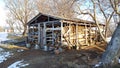 Firewood prepared for winter is piled under an open canopy at the Belogorsky Monastery in Russia. February 2020