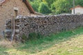 Firewood in row near the bricks wall of village house. Countryside landscape in Bourgogne, France Royalty Free Stock Photo