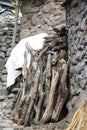 Firewood is stacked in front of a house in a rural area. pile of firewood