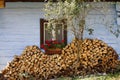 Firewood stacked near the old wooden cabin Royalty Free Stock Photo