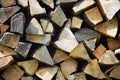 Firewood stacked in a pile outdoor, brown background