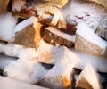 Firewood, wood with snow in winter