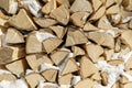 Firewood in woodpile. Wooden background.