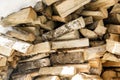 Firewood in woodpile. Wooden background.