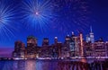 Firework festive fireworks over the night city, Skyscrapers and fireworks in the night sky, reflection of fireworks in the water o Royalty Free Stock Photo