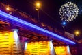 Firework over bridge night city reflected in water Uzhorod