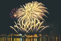 Firework over city at night with reflection in water Royalty Free Stock Photo