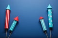 Firework rockets on blue background, flat lay with space for text. Festive decor