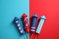 Firework rockets on color background, flat lay. Festive decor