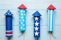 Firework rockets on wooden background, flat lay. Festive decor