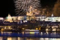 Fireworks above night colorful snowy Prague gothic Castle with Charles Bridge, Czech republic Royalty Free Stock Photo