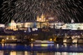 Fireworks above night colorful snowy Prague gothic Castle with Charles Bridge, Czech republic Royalty Free Stock Photo