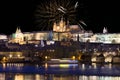 Fireworks above night colorful snowy Prague gothic Castle with Charles Bridge, Czech republic Royalty Free Stock Photo