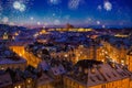 Fireworks above Prague Castle with snowy rooftops during late christmas sunset