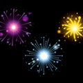 Fireworks bursting in glowing colours magenta light blue yellow on black background