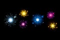Fireworks bursting in glowing multi colours on black background