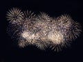 Fireworks display on dark sky background. Flashes of red and white fireworks against the night black sky. Brightly colorful Royalty Free Stock Photo