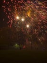 Fireworks display exploding over people and families watching