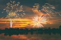 Fireworks display on majestic beautiful sunset sky lake s