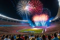 Fireworks Erupting in the Night Sky Above a Stadium Filled with Excited Spectators: Bursts of Color Illuminate the Celebration Royalty Free Stock Photo