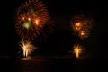 Fireworks explosions with shining sparks on dark background Royalty Free Stock Photo