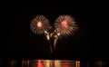 Fireworks festive celebration light show at night over the water. Royalty Free Stock Photo