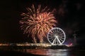 Fireworks light up the sky over the beach in Scheveningen, Holland with spinning Ferris Wheel at the pier Royalty Free Stock Photo