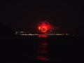 Fireworks over the city in distance the river with reflection in the water Royalty Free Stock Photo