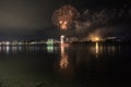 The fireworks paint the sky in various colors and are reflected in the Miseno lake, creating a breathtaking view.