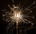 Fireworks sparkler showing through LED light bulb Royalty Free Stock Photo