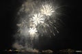 Fireworks and sparks at night over the sea