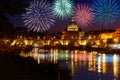 Fireworks on St peter Cathedral skyline in Rome view from Umberto I bridge on Tiber river