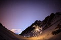 Fireworks on a winter night in mountains