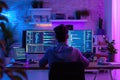 Firmware Creation Brilliance: IT Developer at Work in Neon-Lit Modern Home Office