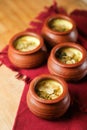 Firni, phirni anf kheer with nuts served in pot isolated on mat top view of indian, bangali and pakistani dessert mithai