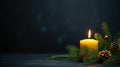 one burning candle on fir branches with Christmas decoration against a dark grey background, c Royalty Free Stock Photo