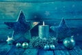 First advent: one burning golden candle on a wooden background. Royalty Free Stock Photo