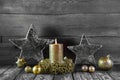 First advent: one golden burning candle on wood for decorations. Royalty Free Stock Photo