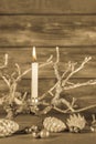 First advent: one white burning candle on wooden rustic background with natural decoration. Royalty Free Stock Photo