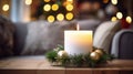 First Advent, wreath with one burning white candle and Christmas decoration on a wooden table in front of the couch, festive home Royalty Free Stock Photo