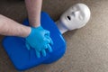 First aid and cardiopulmonary resuscitation training on a CPR dummy, a human shaped doll used to improve the skills and technique